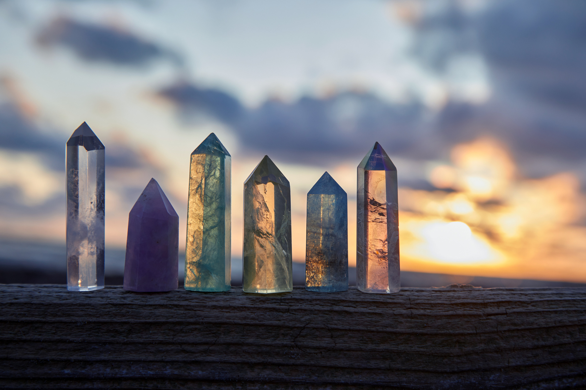 Healing Reiki Crystals on Wood by the Sea at Sunset
